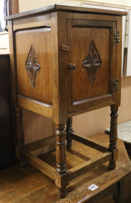 A carved oak bedside cupboard W.42cm